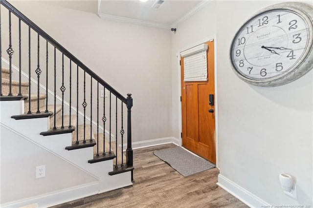 foyer with crown molding and wood-type flooring