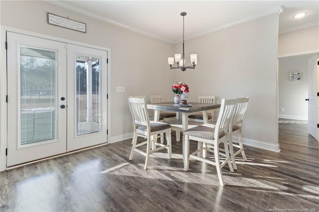 dining space featuring crown molding, dark hardwood / wood-style floors, french doors, and a chandelier