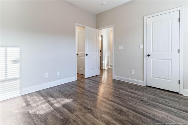 unfurnished bedroom with dark hardwood / wood-style floors