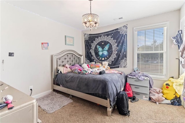 carpeted bedroom with a notable chandelier