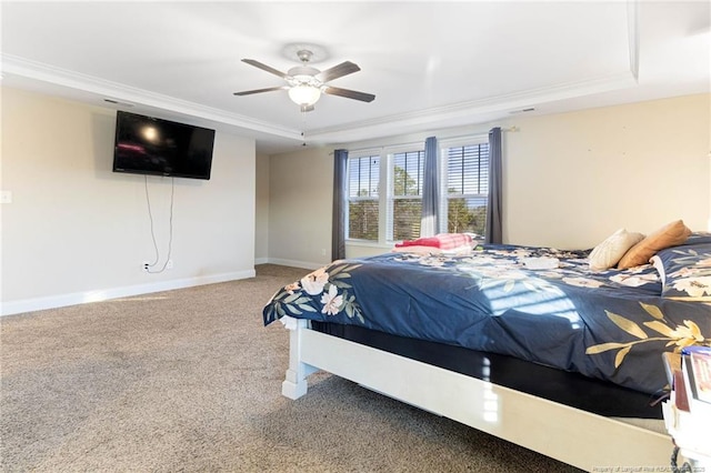 bedroom featuring ornamental molding, a raised ceiling, ceiling fan, and carpet