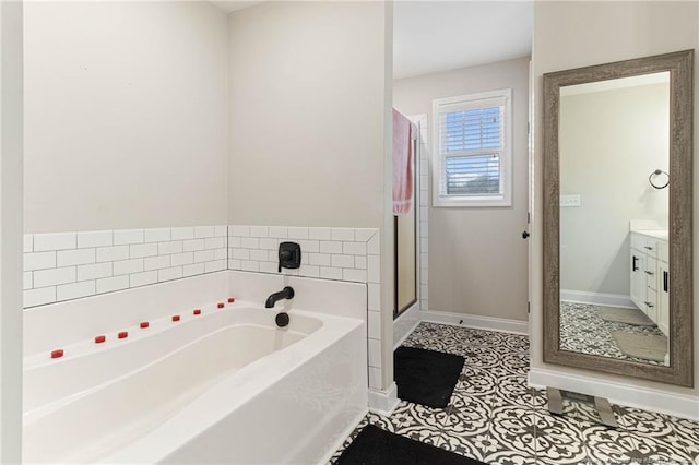 bathroom featuring vanity, a bathtub, and tile patterned floors