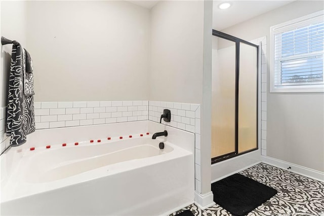 bathroom with tile patterned floors and shower with separate bathtub