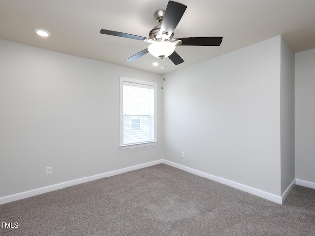 spare room featuring ceiling fan and carpet