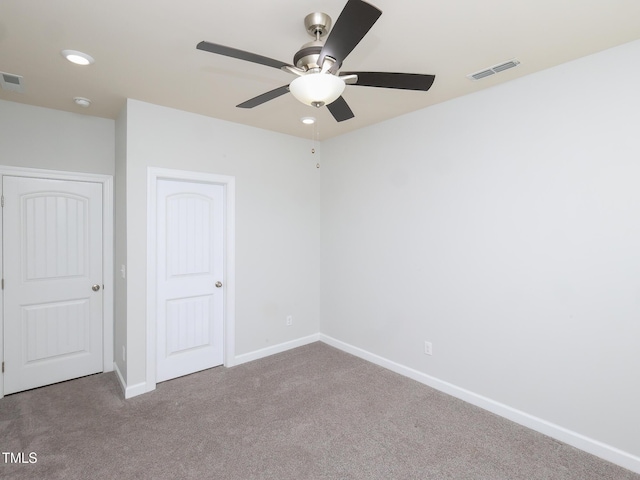 unfurnished bedroom with ceiling fan and carpet