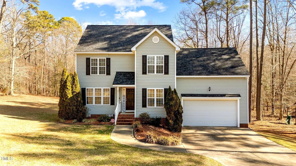 view of front of home featuring a garage and a front yard