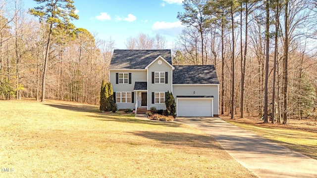 view of front of property featuring a garage and a front yard