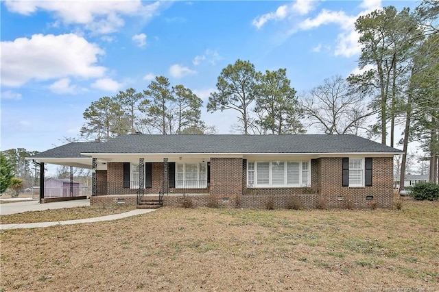 ranch-style house featuring a porch, a carport, and a front yard