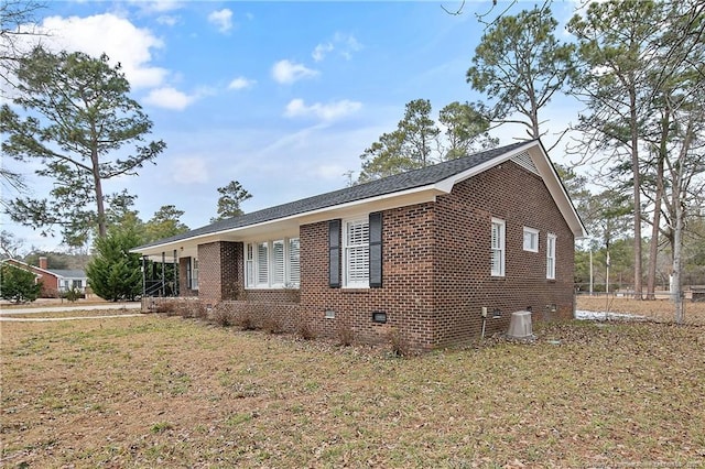 view of side of property with a yard