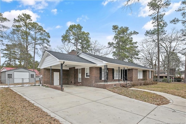 ranch-style house with a garage, an outdoor structure, and a porch