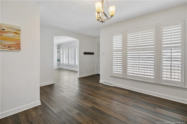 unfurnished dining area with a chandelier and dark hardwood / wood-style flooring