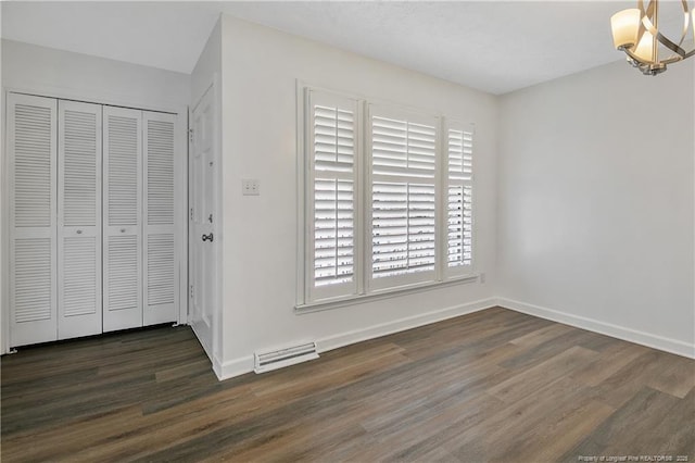 entrance foyer featuring dark hardwood / wood-style flooring and an inviting chandelier