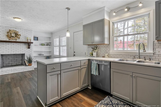 kitchen featuring gray cabinets, decorative light fixtures, dishwasher, sink, and kitchen peninsula