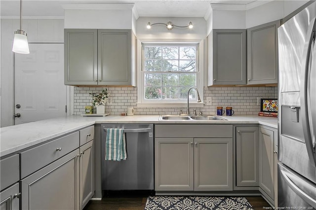 kitchen with gray cabinets, appliances with stainless steel finishes, sink, and decorative backsplash