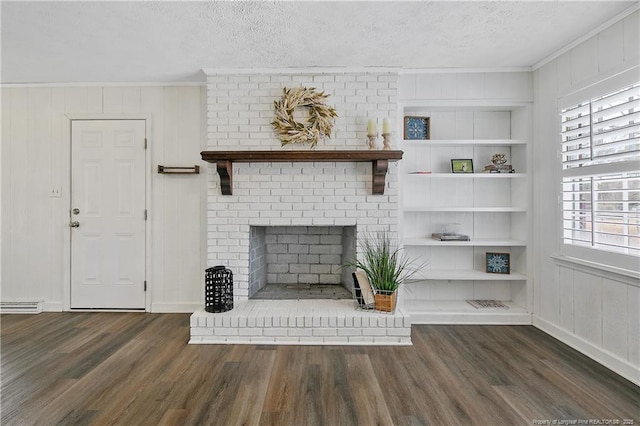 unfurnished living room featuring dark hardwood / wood-style flooring, built in features, a textured ceiling, and a fireplace