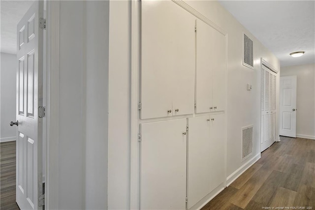 hallway with dark wood-type flooring