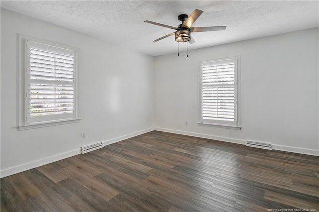 spare room with a textured ceiling, dark hardwood / wood-style floors, and ceiling fan