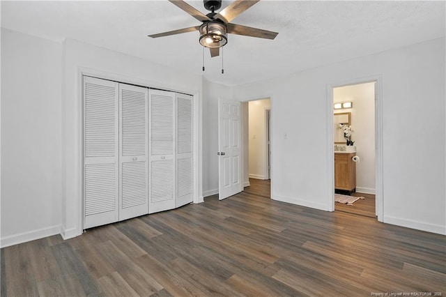 unfurnished bedroom featuring dark hardwood / wood-style floors, connected bathroom, ceiling fan, and a closet