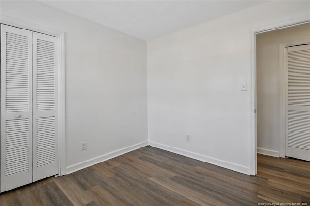 unfurnished bedroom featuring dark hardwood / wood-style floors