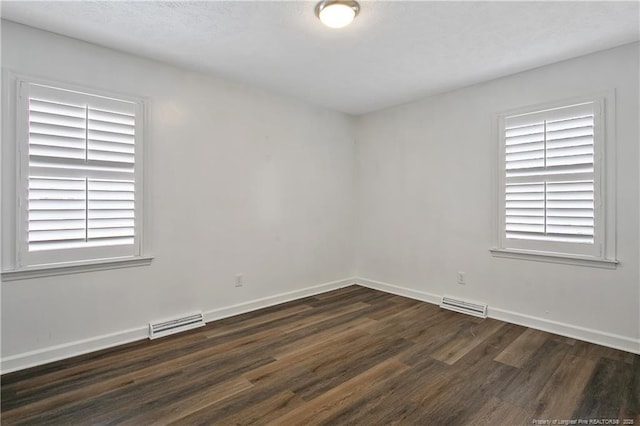 spare room featuring dark hardwood / wood-style flooring