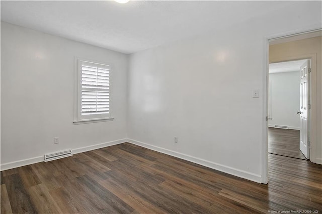 empty room featuring dark hardwood / wood-style floors