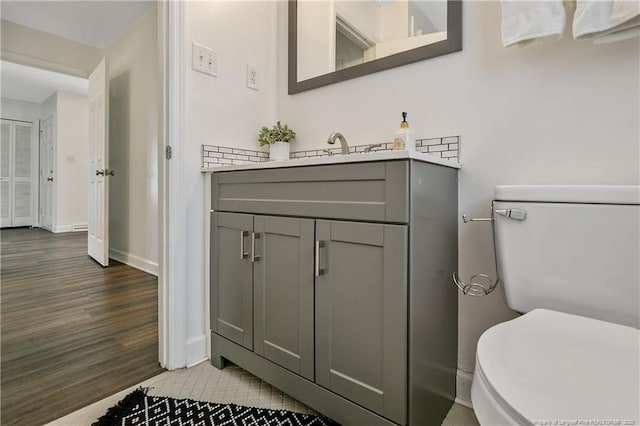 bathroom featuring hardwood / wood-style flooring, vanity, and toilet