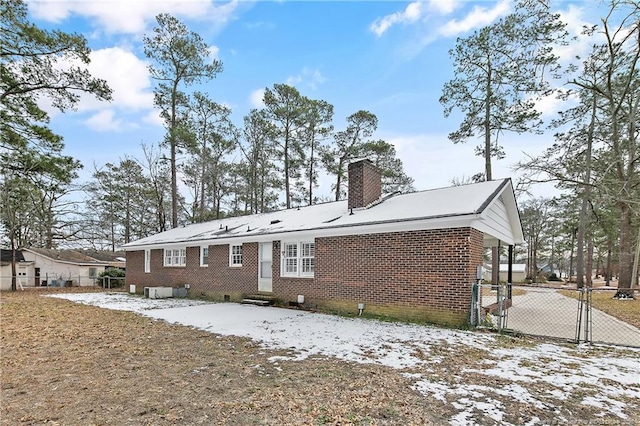 view of snow covered rear of property