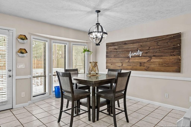 tiled dining space featuring an inviting chandelier and a textured ceiling