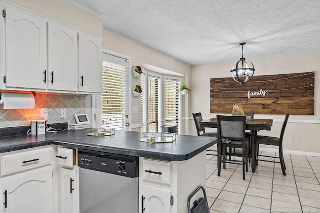 kitchen featuring decorative light fixtures, light tile patterned floors, stainless steel dishwasher, white cabinets, and backsplash