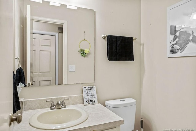 bathroom with vanity and toilet