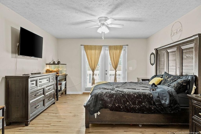 bedroom featuring a textured ceiling, light hardwood / wood-style flooring, and ceiling fan