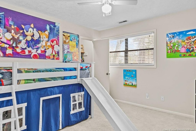 carpeted bedroom with a textured ceiling and ceiling fan