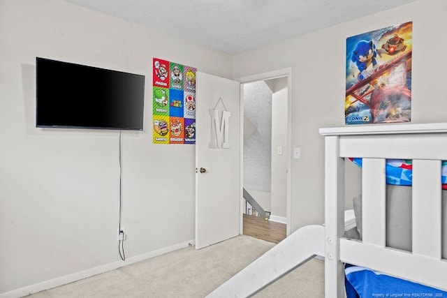 carpeted bedroom featuring a textured ceiling