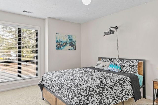 carpeted bedroom featuring a textured ceiling