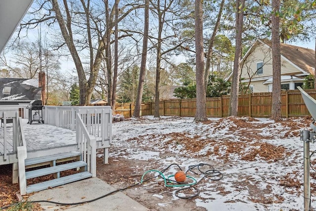 snowy yard with a wooden deck