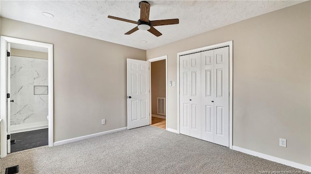 unfurnished bedroom featuring a textured ceiling, light colored carpet, a closet, and ceiling fan