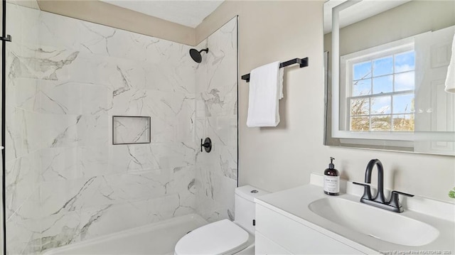 bathroom featuring vanity, toilet, and a tile shower