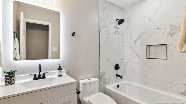 full bathroom featuring vanity, toilet, and tiled shower / bath