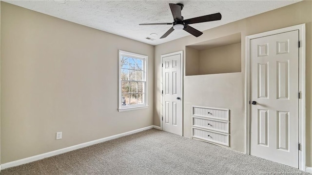 unfurnished bedroom with a textured ceiling, ceiling fan, and carpet flooring