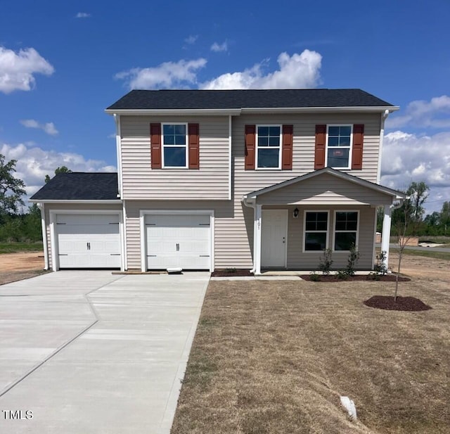 view of front of house featuring concrete driveway and a garage