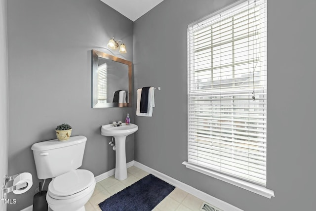 bathroom featuring sink, a wealth of natural light, tile patterned floors, and toilet