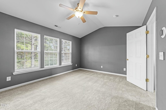 interior space featuring light carpet, vaulted ceiling, and ceiling fan