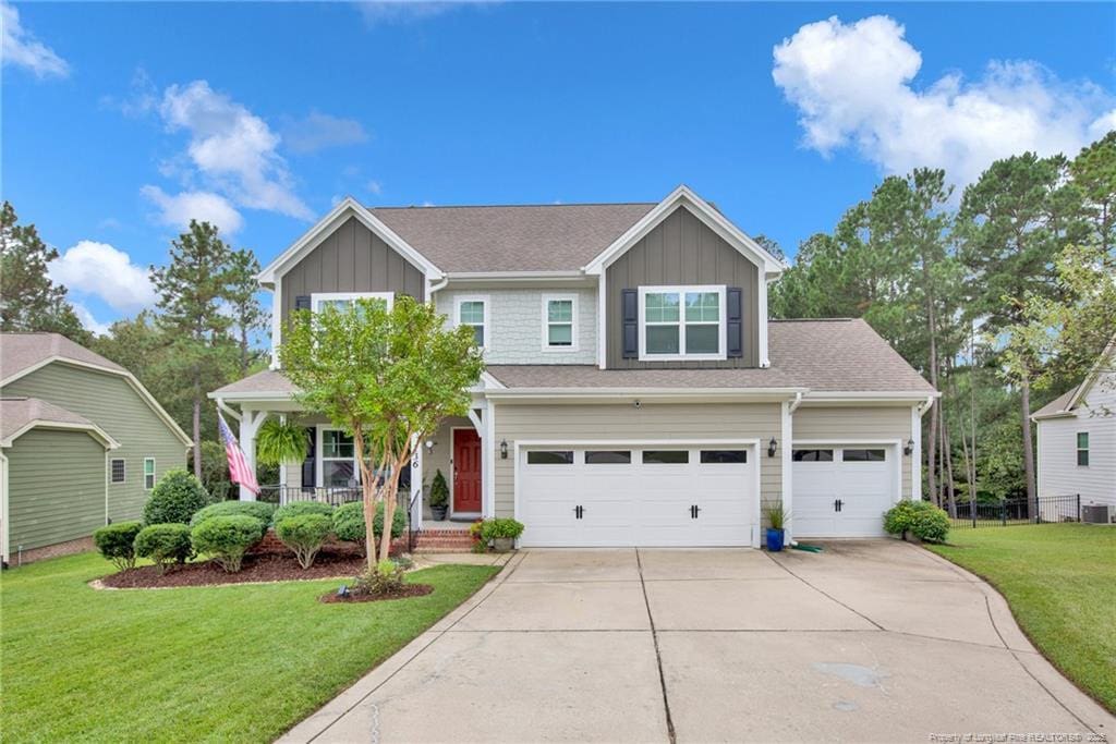 view of front of home featuring a garage, a porch, and a front yard