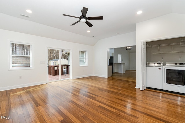 unfurnished living room with recessed lighting, wood finished floors, vaulted ceiling, and separate washer and dryer