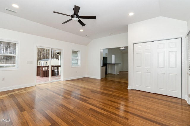 unfurnished living room featuring lofted ceiling, recessed lighting, dark wood-type flooring, visible vents, and baseboards