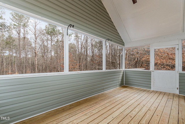 unfurnished sunroom featuring vaulted ceiling