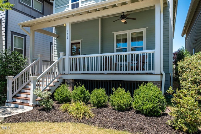 entrance to property featuring covered porch and ceiling fan