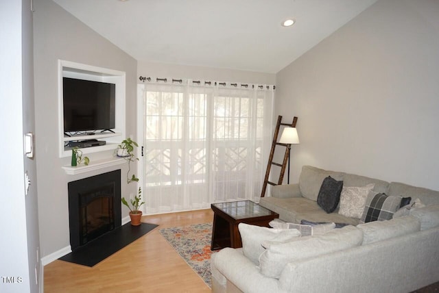 living room featuring hardwood / wood-style flooring and lofted ceiling