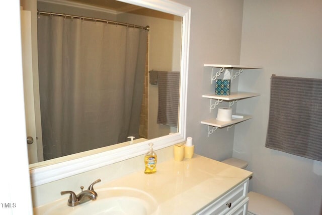 bathroom with vanity, curtained shower, and toilet