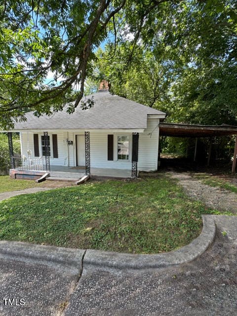 view of front of property featuring a carport and covered porch